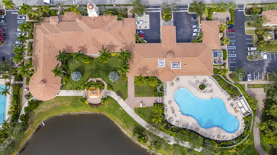 Aerial view of the Town Center, resort-style pool, and clubhouse at Village Walk of Bonita Springs, a gated community with homes for sale in Bonita Springs, FL