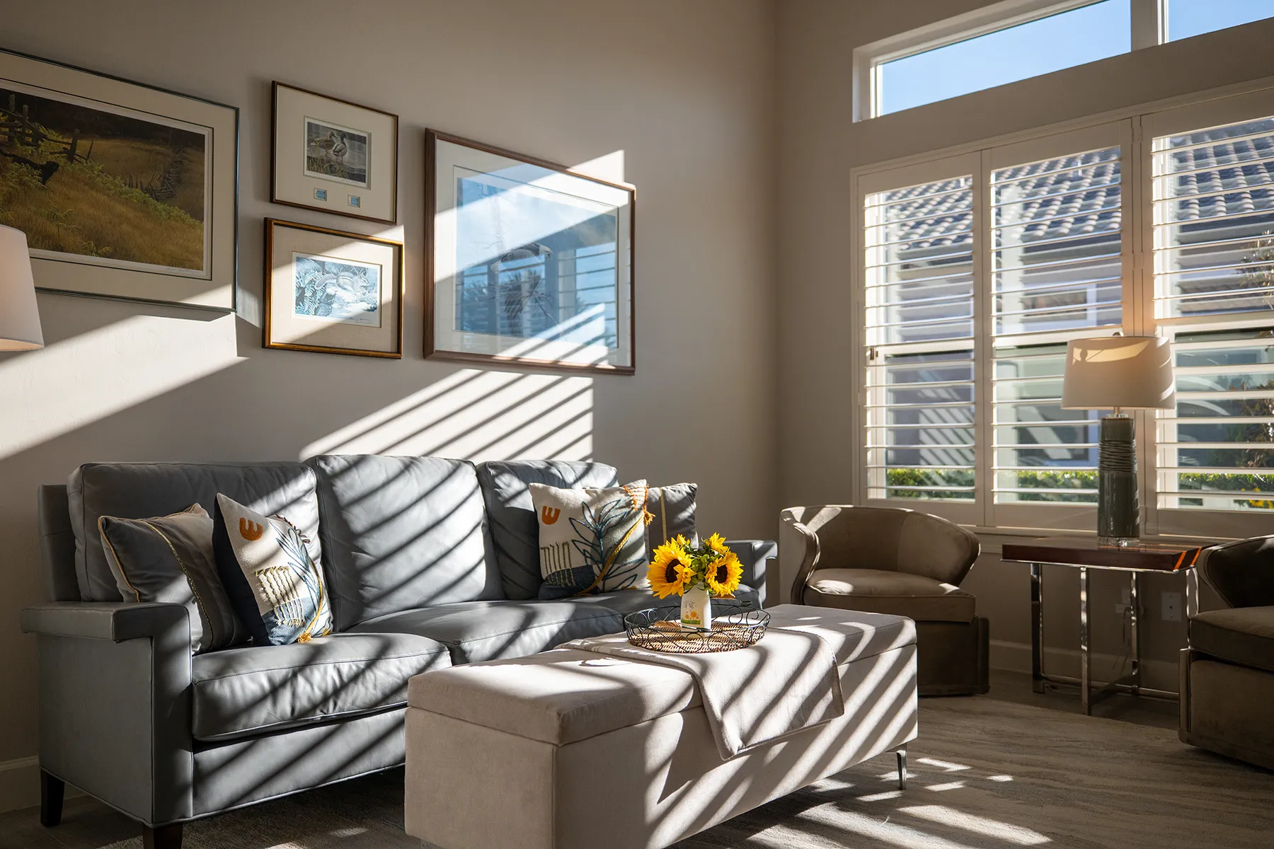 Sunlit living room with plantation shutters in a Southwest Florida home