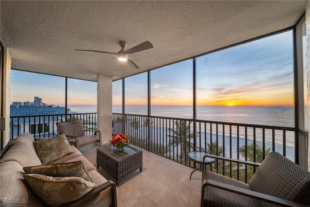 Screened wraparound balcony with Gulf sunset views at Bayshores of Vanderbilt Beach Naples Florida