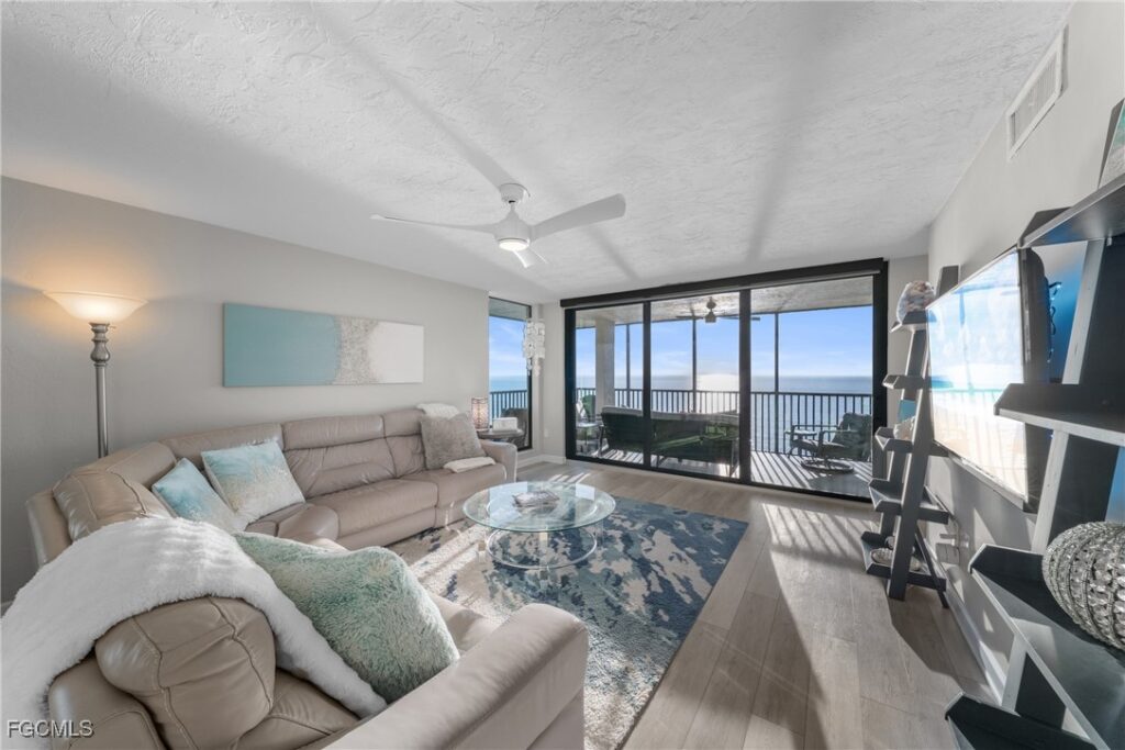 Renovated living room with Gulf views through sliding glass doors at Bayshores Vanderbilt Beach Naples Florida