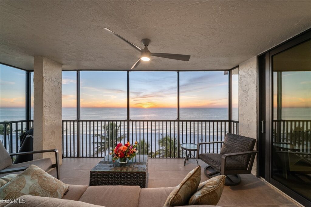 Screened Gulf-front lanai at sunset in top-floor condo at Bayshores of Vanderbilt Beach Naples Florida