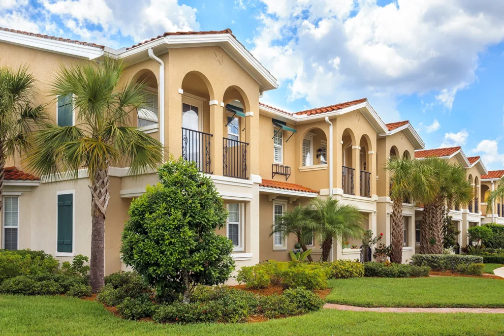 Mediterranean townhomes with arched balconies and terra cotta roofs in Naples