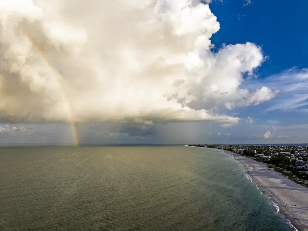 Rainbow over Southwest Florida Gulf Coast beach after storm, aerial view