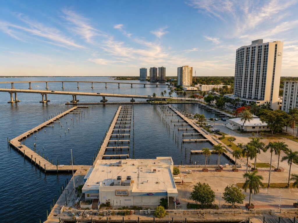Aerial view of the Fort Myers Yacht Basin's empty pilings west of the Edison Bridge with downtown's Edison Grand Apartments in the background
