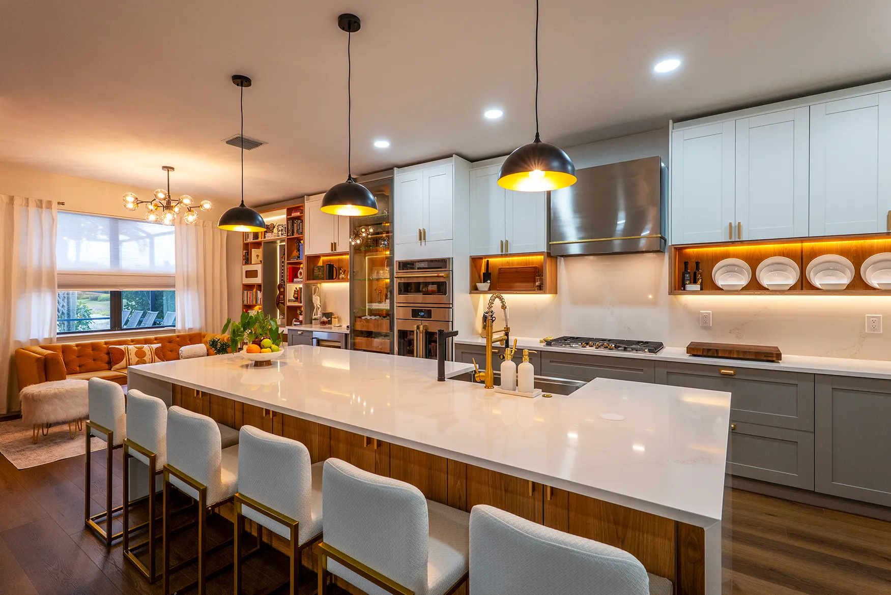 A modern Southwest Florida kitchen with a large island, pendant lighting, and counter seating