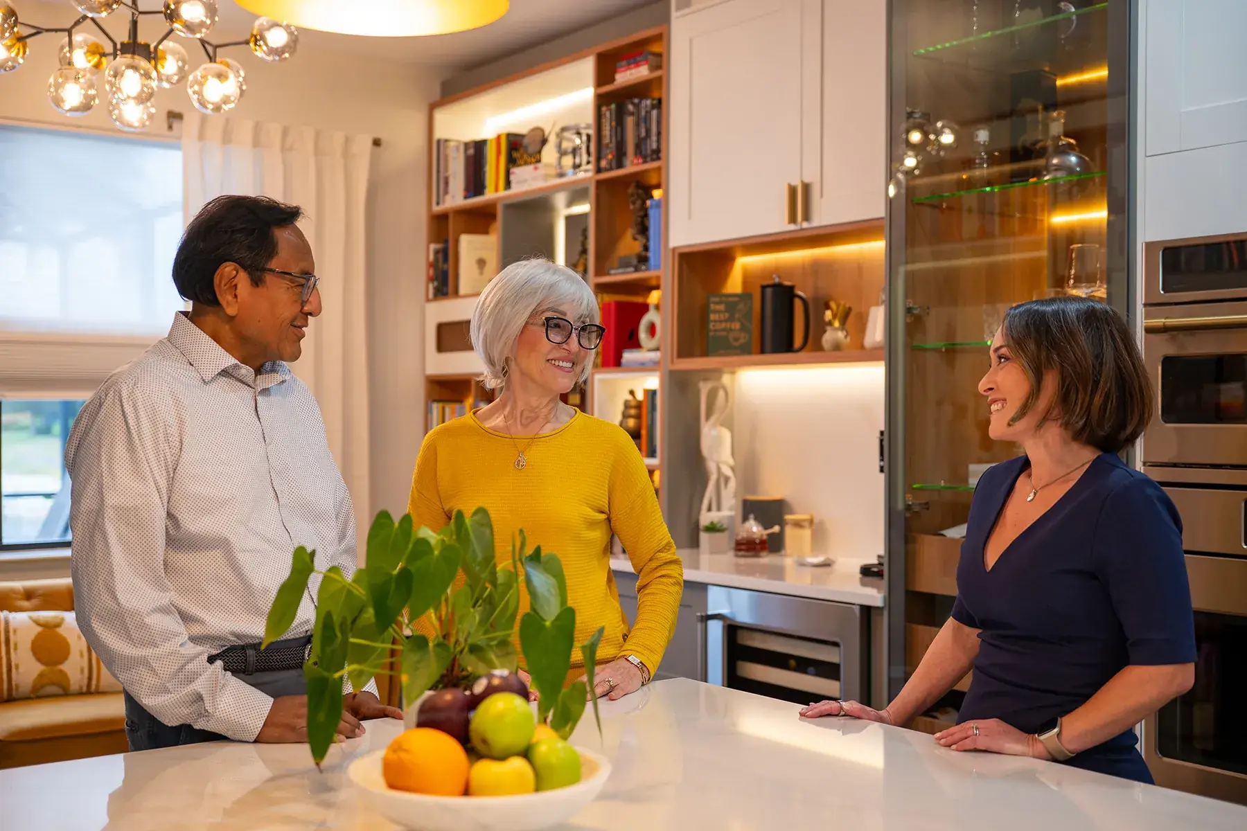 Worthington Realty agent Susana Alvarez Davis talking with homeowners in their kitchen